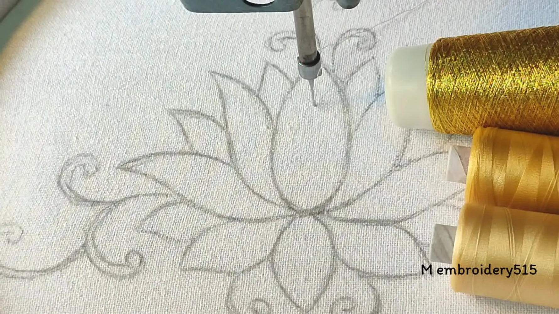 Machine embroidery setup with design outline and threads