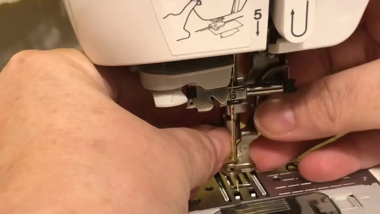 Close-up of a new Brother-style Q foot aligned and snapped into position on the presser bar, ready to be tightened and tested for needle clearance.