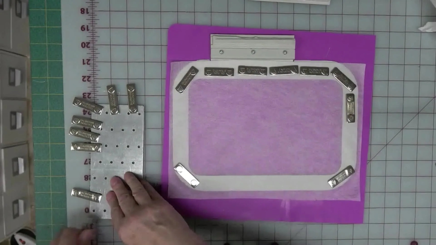 A generic magnetic hoop sits fully loaded with low-profile magnets around taut stabilizer, ready to stitch without slipping.