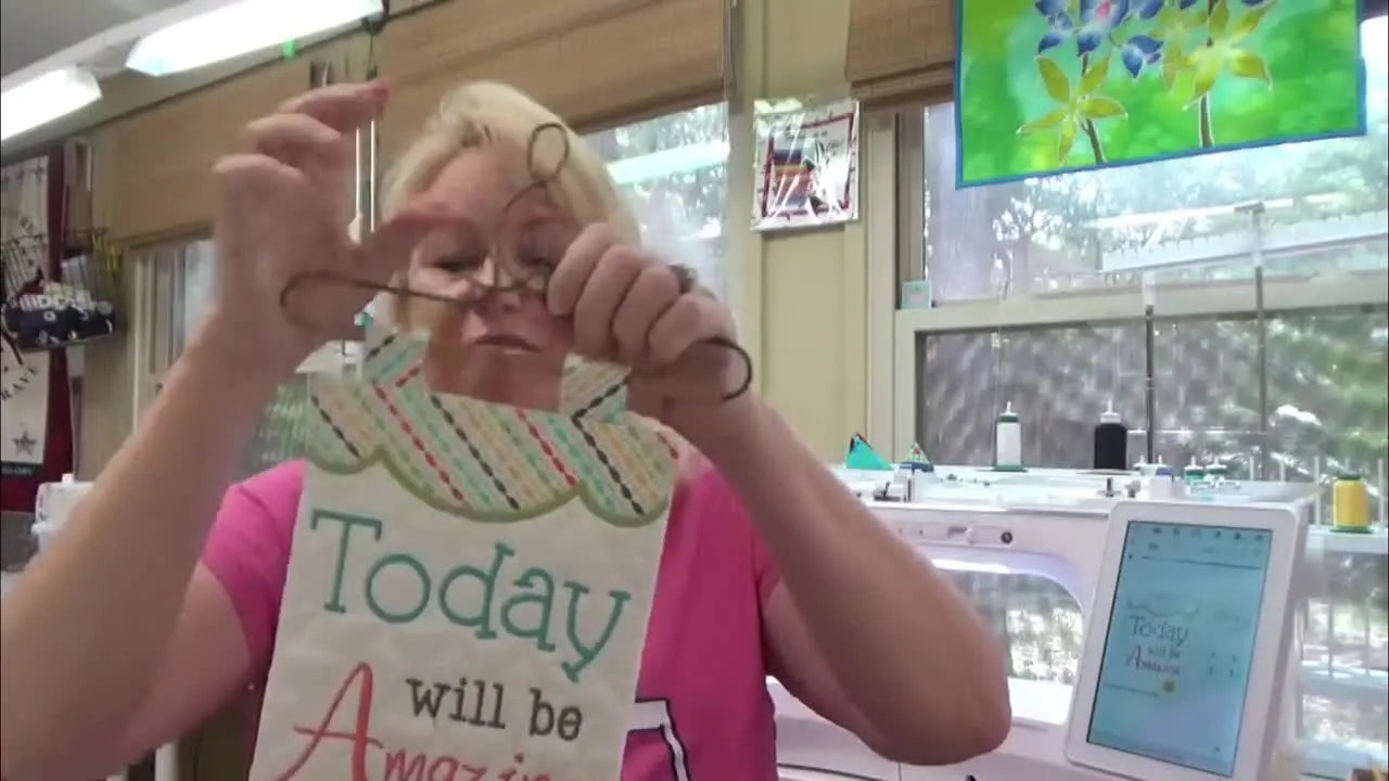 The finished “Today will be Amazing” mini wall hanging is held up on a small wire hanger, showing the clean front and professional shape.