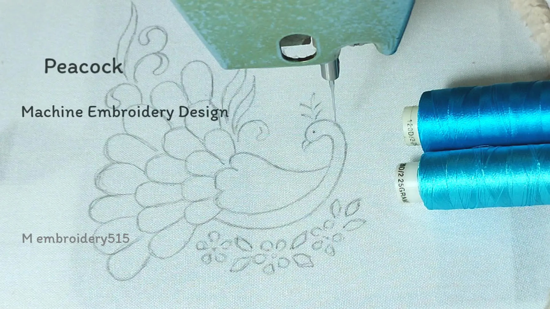 Embroidery machine ready to stitch a peacock design on white fabric