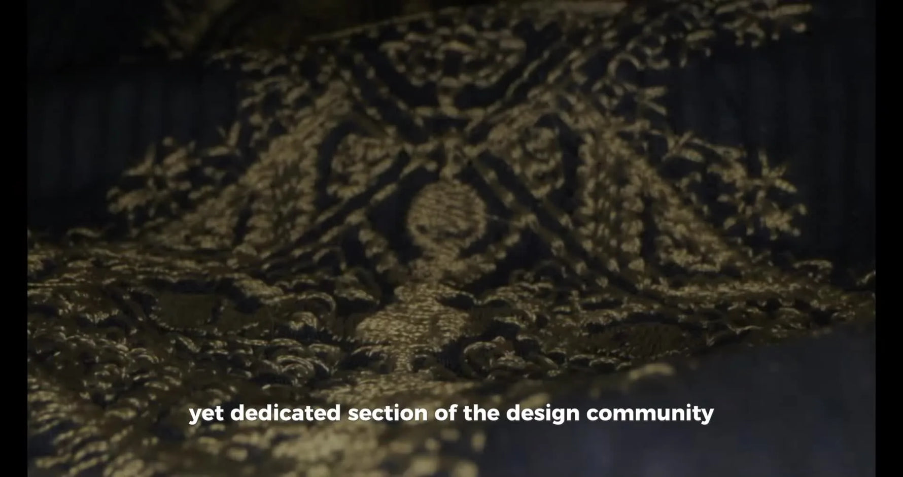 A close-up pan across dense gold satin stitches on dark blue fabric, highlighting the kind of stitch quality you want to preserve when converting legacy PEM designs.