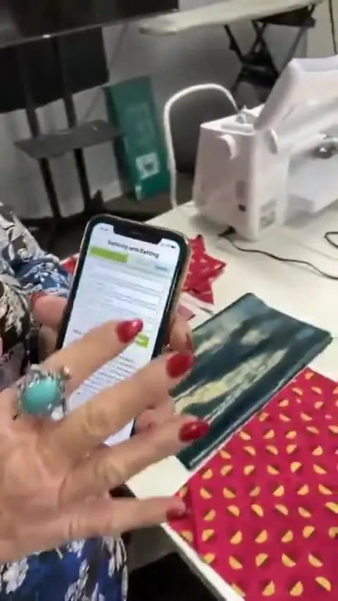 A close-up of a phone running the Quilting Calc app, ready to calculate backing and batting yardage without guesswork.
