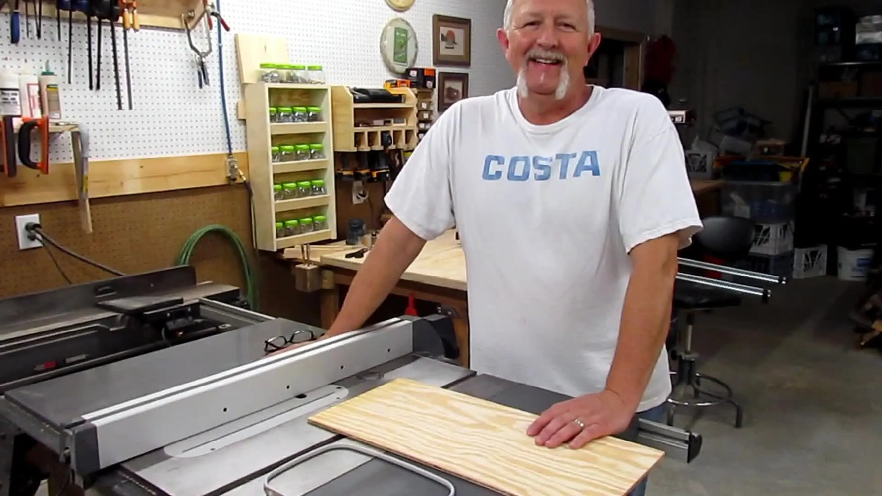 Man presenting DIY cap embroidery holder project.