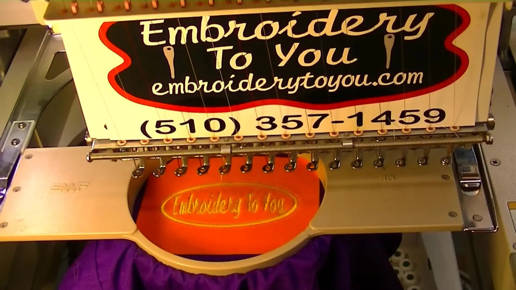 A close-up shows a hand ripping away excess orange flock cleanly from the satin-stitched oval on a purple dress shirt.