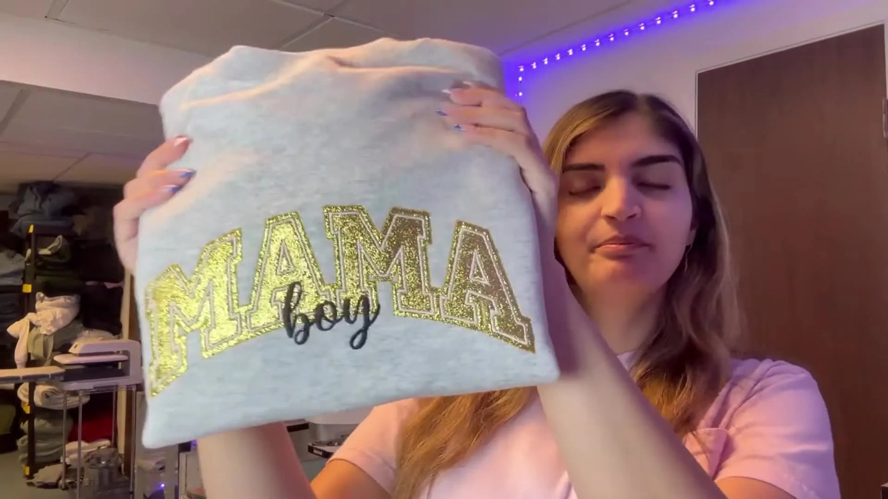 A finished grey sweatshirt featuring a gold glitter “MAMA” appliqué with clean satin borders and the word “boy” stitched beneath.