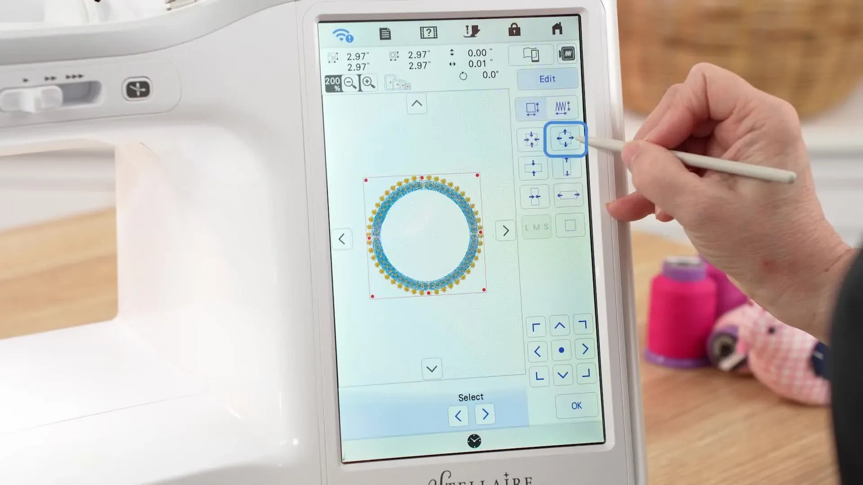 Close-up of the Brother embroidery machine stitching a teal satin circle layer inside the hoop.