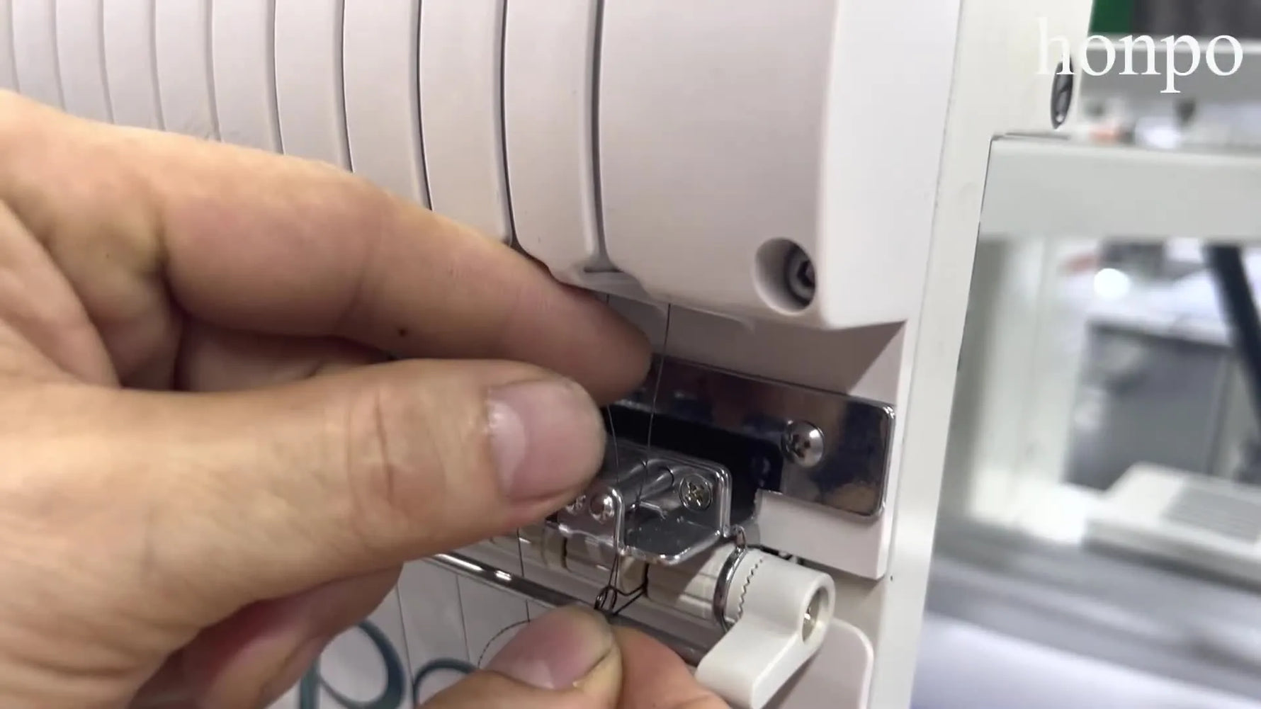 A clear mid-shot of the Honpo multi-needle head showing the overall threading path context before finishing at the needle area.