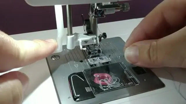 An extreme close-up of the EverSewn Sparrow X2 automatic needle threader lowered into position around the needle.