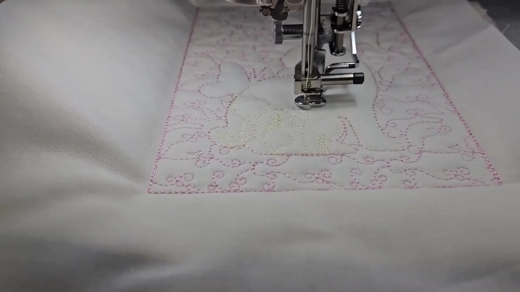 A finished Flower Easter Bunny quilt block is shown neatly framed, highlighting the stippled background and the yellow bunny motif stitched inside the reserved negative space.