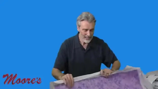 The presenter holds the Brother 7x14 magnetic sash frame while explaining its V-shape profile and magnet clamping action for quilting and re-hooping.