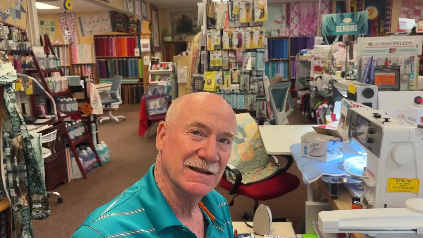 Bernina Jeff in his quilt shop, smiling at the camera.