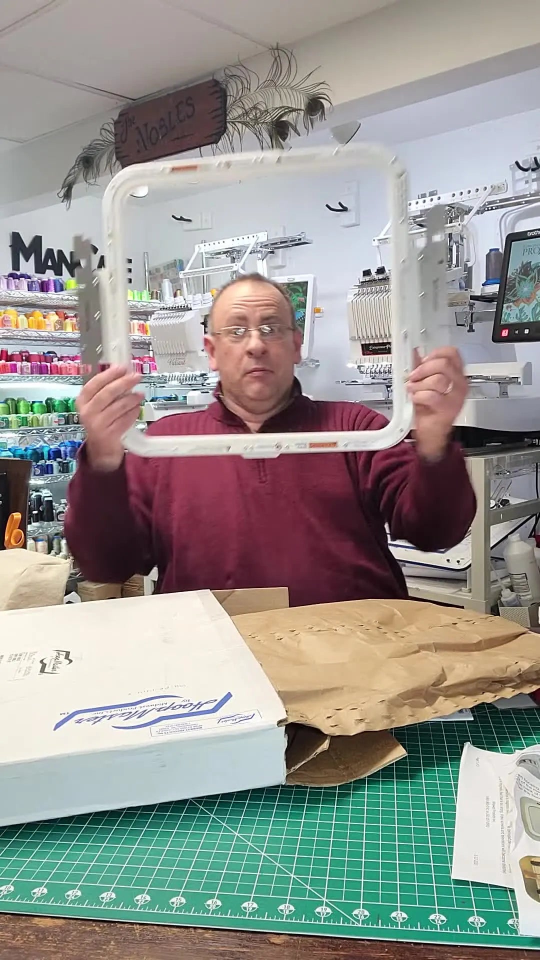 Jerry pulls a large 14x14 magnetic hoop from its packaging, showing the scale of the frame for big embroidery projects.