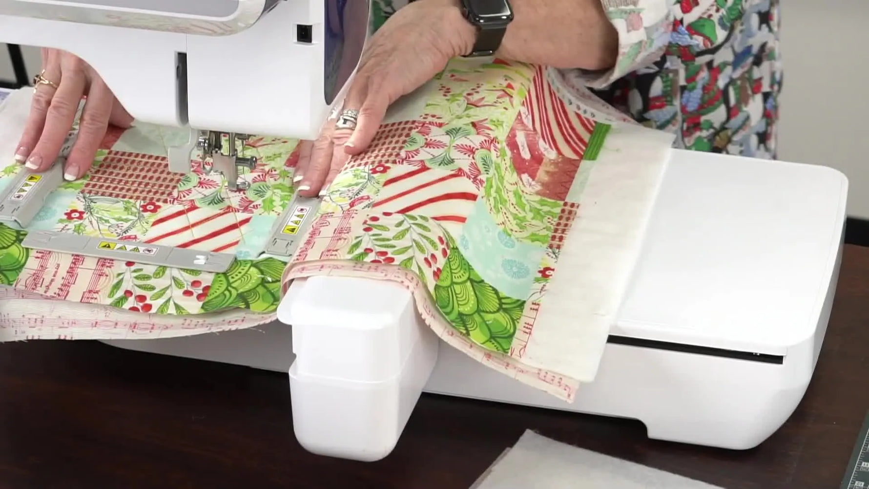 A close-up shows the top magnetic frame snapping onto a quilt sandwich, demonstrating fast, even hooping without clamp marks.