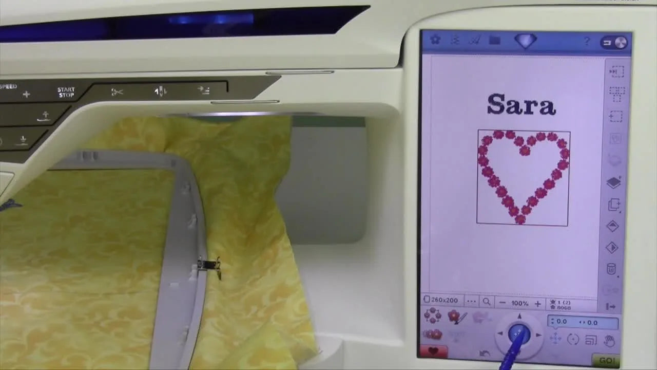 A close-up of the Diamond Royale screen as the stylus points to the center bullseye button used to instantly re-center a design in the hoop.