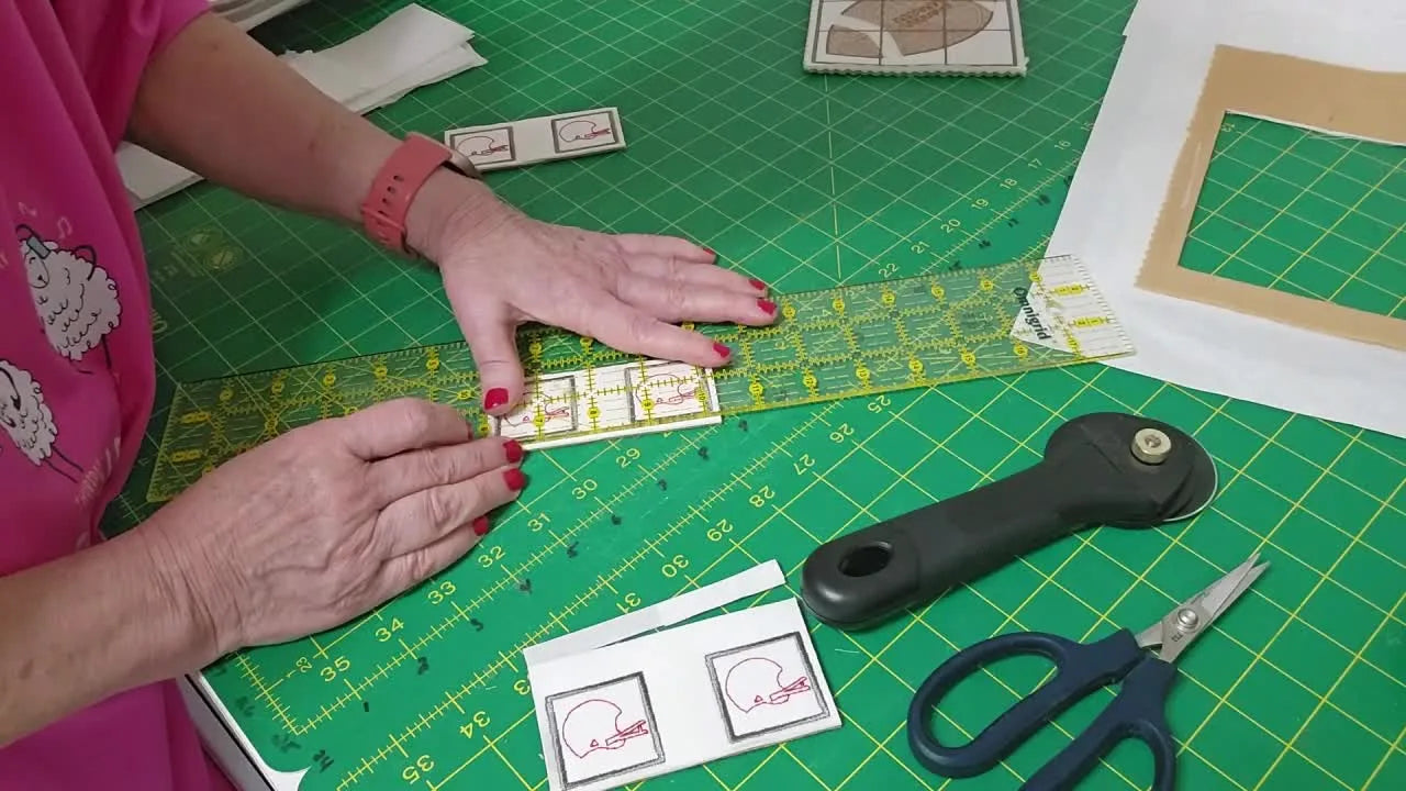 All finished ITH football Tic Tac Toe pieces are neatly trimmed and arranged around the completed game board, ready to slide into the storage pocket.