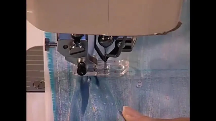 A close-up shows a pointed tool forming a small fabric hump under the presser foot as the Sashiko stitch locks each pleat in place.