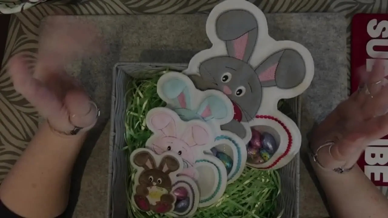 A basket filled with finished felt ITH bunny treat holders displayed as ready-to-gift Easter projects.