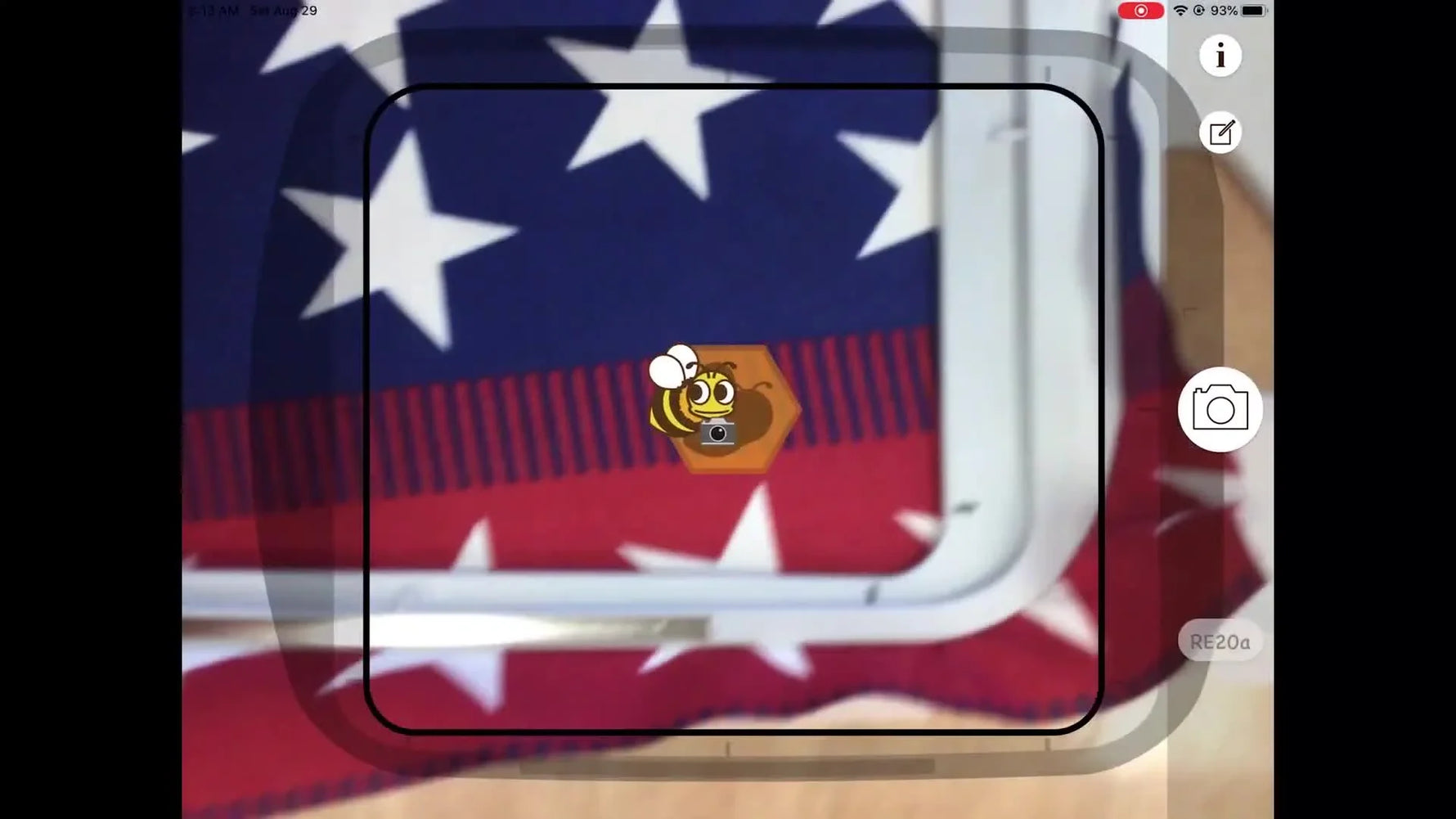 An overhead view of the iPad running AcuSetter, showing the AR overlay aligned to a hooped US flag fabric for precise embroidery placement.