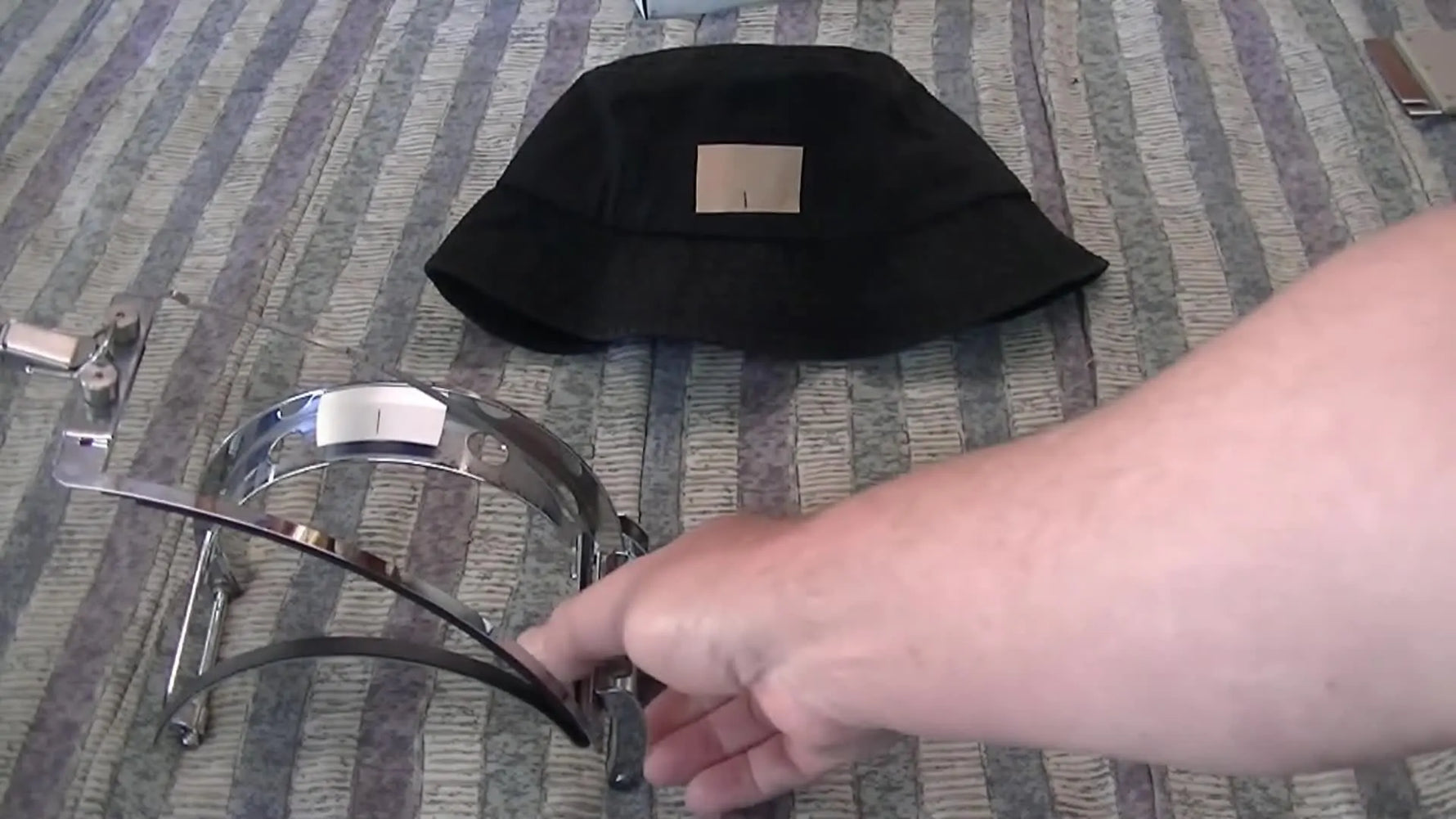 A close-up of the correct bucket cap frame being held up, highlighting the specialized hoop needed for full-brim hats.