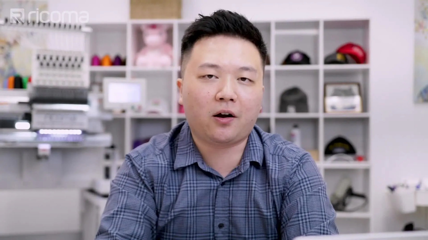 A close-up shows a technician using a yellow-handled screwdriver to adjust the head area of a multi-needle embroidery machine.