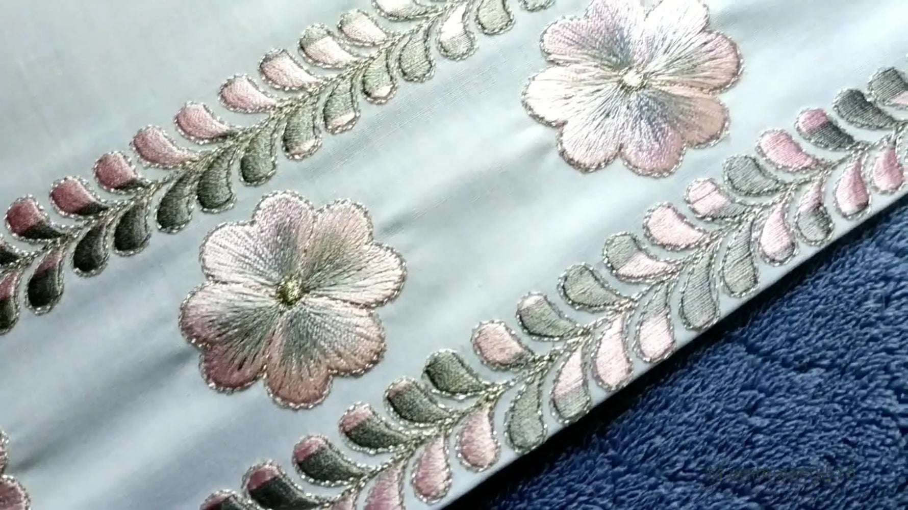 Overview of the finished embroidered fabric with borderlines and flowers