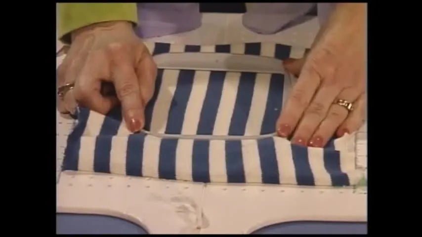 Lindy demonstrates the pivot motion that snaps the inner hoop into the outer hoop while keeping fabric aligned and tension even.