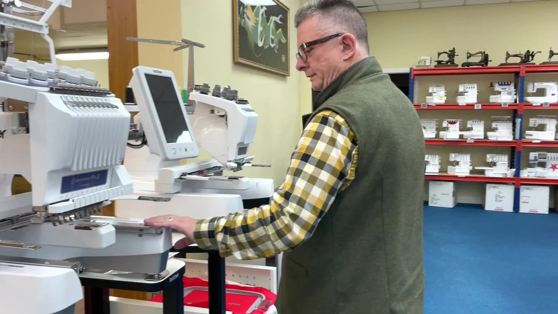Brother PR1055X and PR680W demo embroidery machines displayed on stands in the showroom.