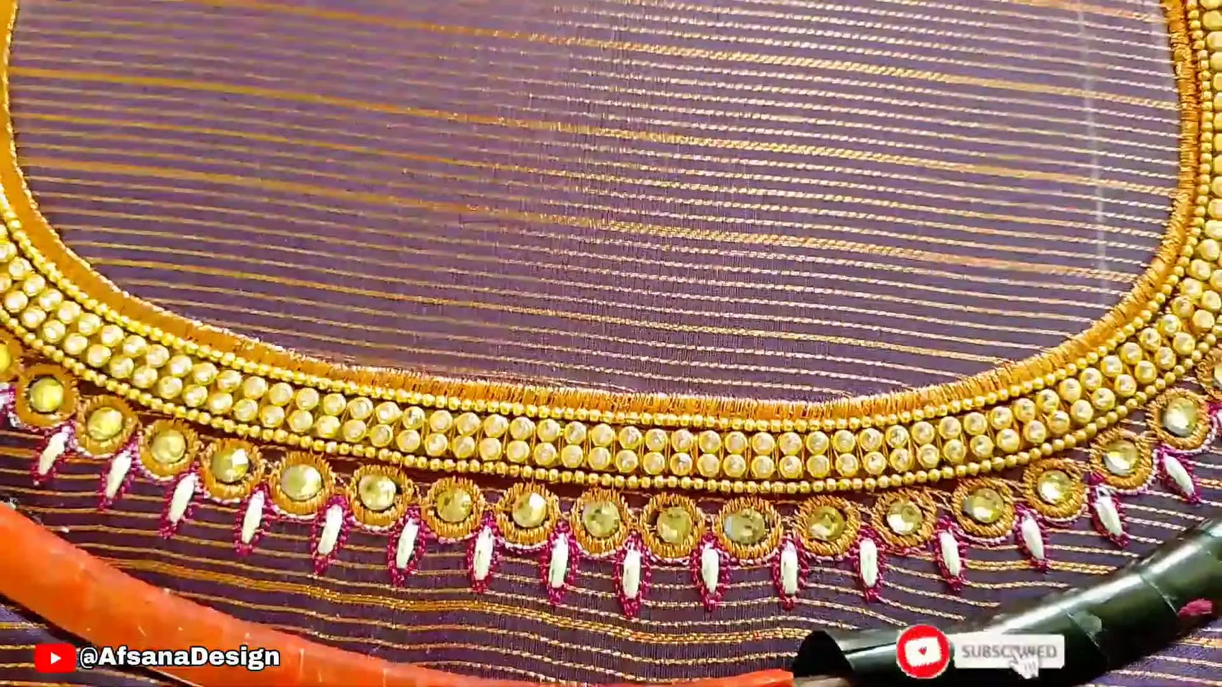 A wide top-down view of the finished heavy bridal blouse neckline design stitched on purple fabric inside a round hoop.