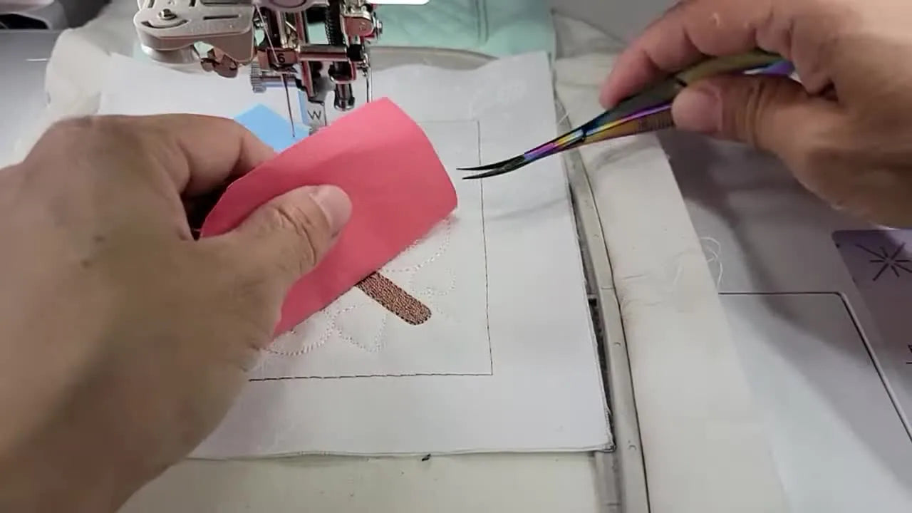 A tri-colored (blue/white/pink) popsicle is fully pieced in the hoop on the Brother Luminaire 2, ready for satin stitching.