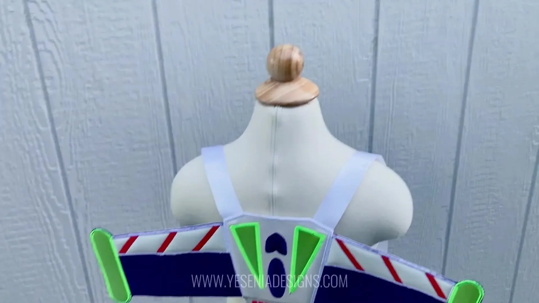 Finished Buzz Lightyear-inspired ITH wings displayed on a mannequin, showing the full shape, center connector, and wearable strap placement.