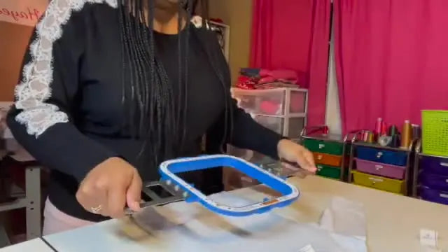 A magnetic hoop clamps down on a children’s shirt in one decisive snap, locking the garment straight for fast, repeatable production.