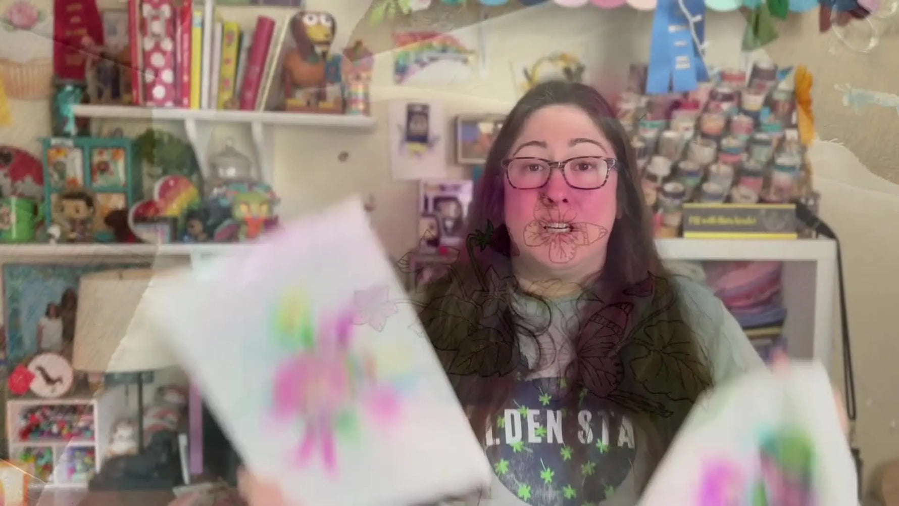 The finished floral outline embroidery has been watercolored and mounted tightly on a canvas frame for display.