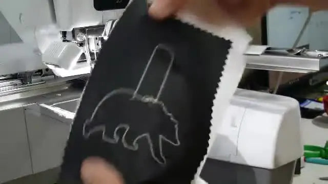 A cosmetic bag is stretched snugly over the Fast Frame size E, clipped in place for clean, fast embroidery without traditional hooping pressure.