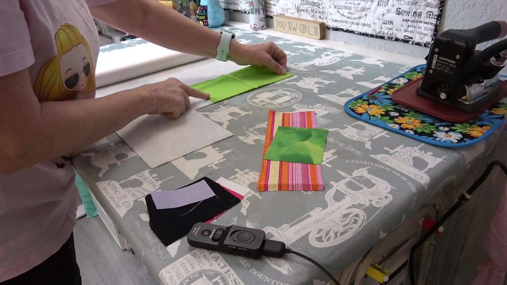 Overhead view of fabric scraps arranged tightly on HeatnBond Lite like a Tetris layout for efficient applique prep.