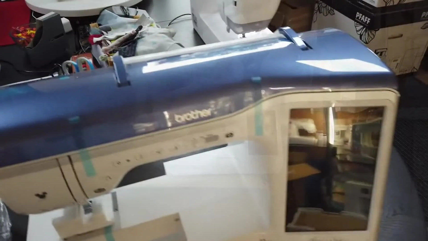 The Brother Innov-is XJ1 Stellaire sits fully revealed on a sturdy table, ready for tape removal and first power-on checks.