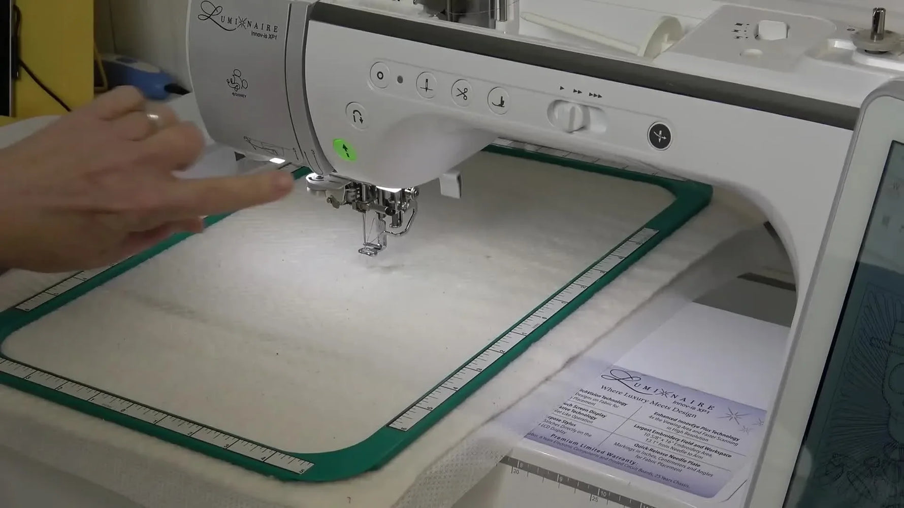 A Brother Luminaire stitches placement lines on batting held in a green magnetic embroidery hoop, setting up a multi-step Snapplique appliqué sequence.