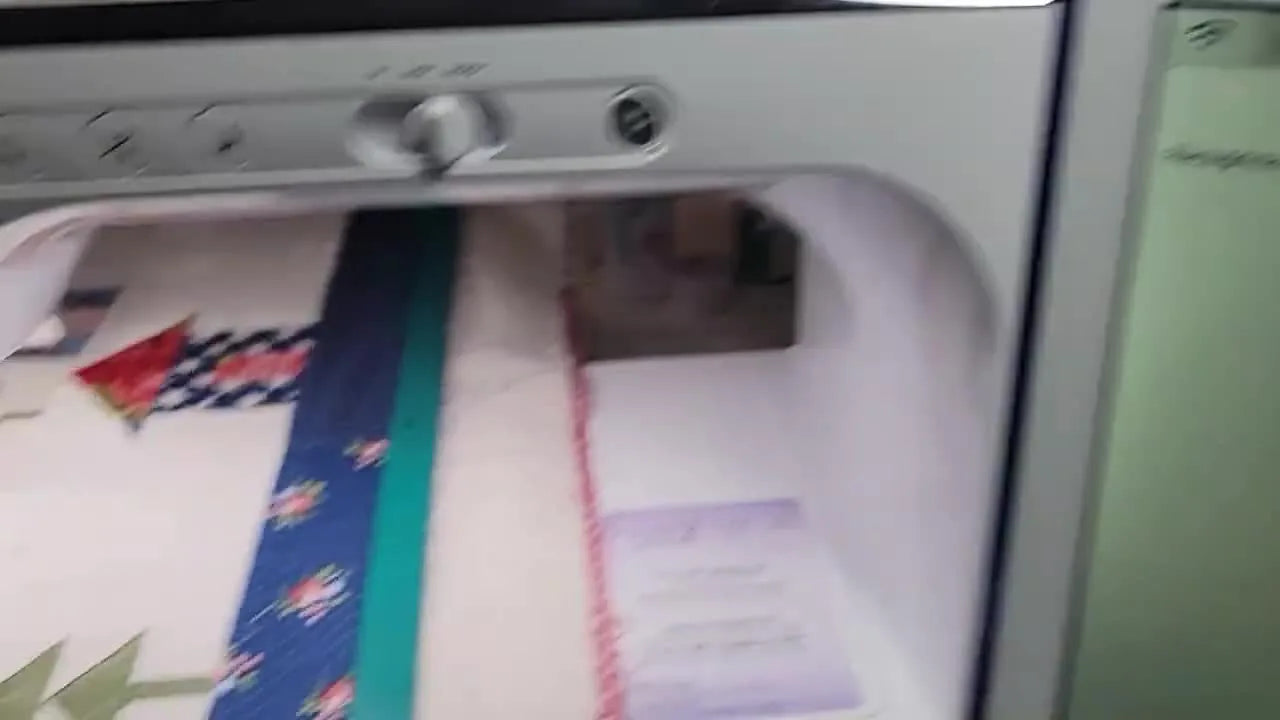 The Brother Luminaire screen shows a background scan of the hooped quilt block with the quilting design overlaid for precise placement.