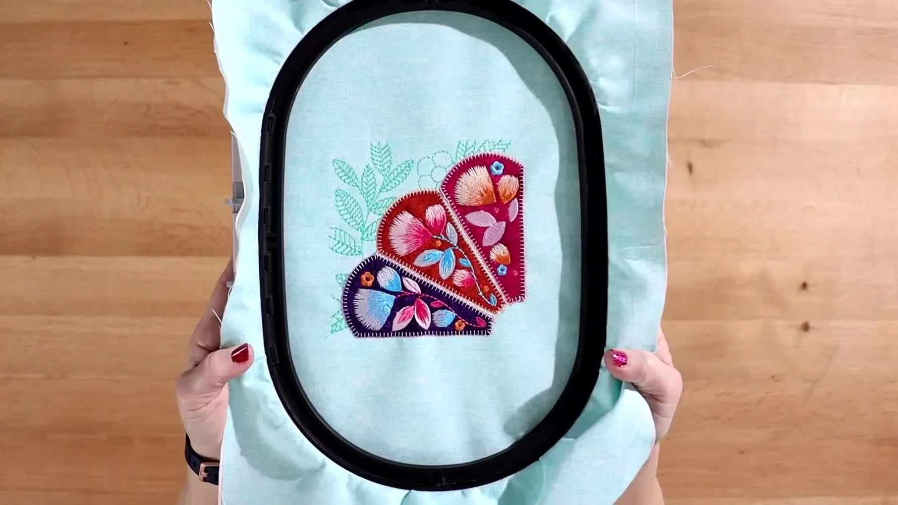 A fully stitched Floral Dresden Applique block sits in the hoop, showing crisp satin edges and colorful floral details ready for trimming and assembly.