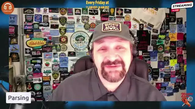 A close-up frame of the presenter emphasizing the importance of parsing a large embroidery design into manageable pieces before digitizing.