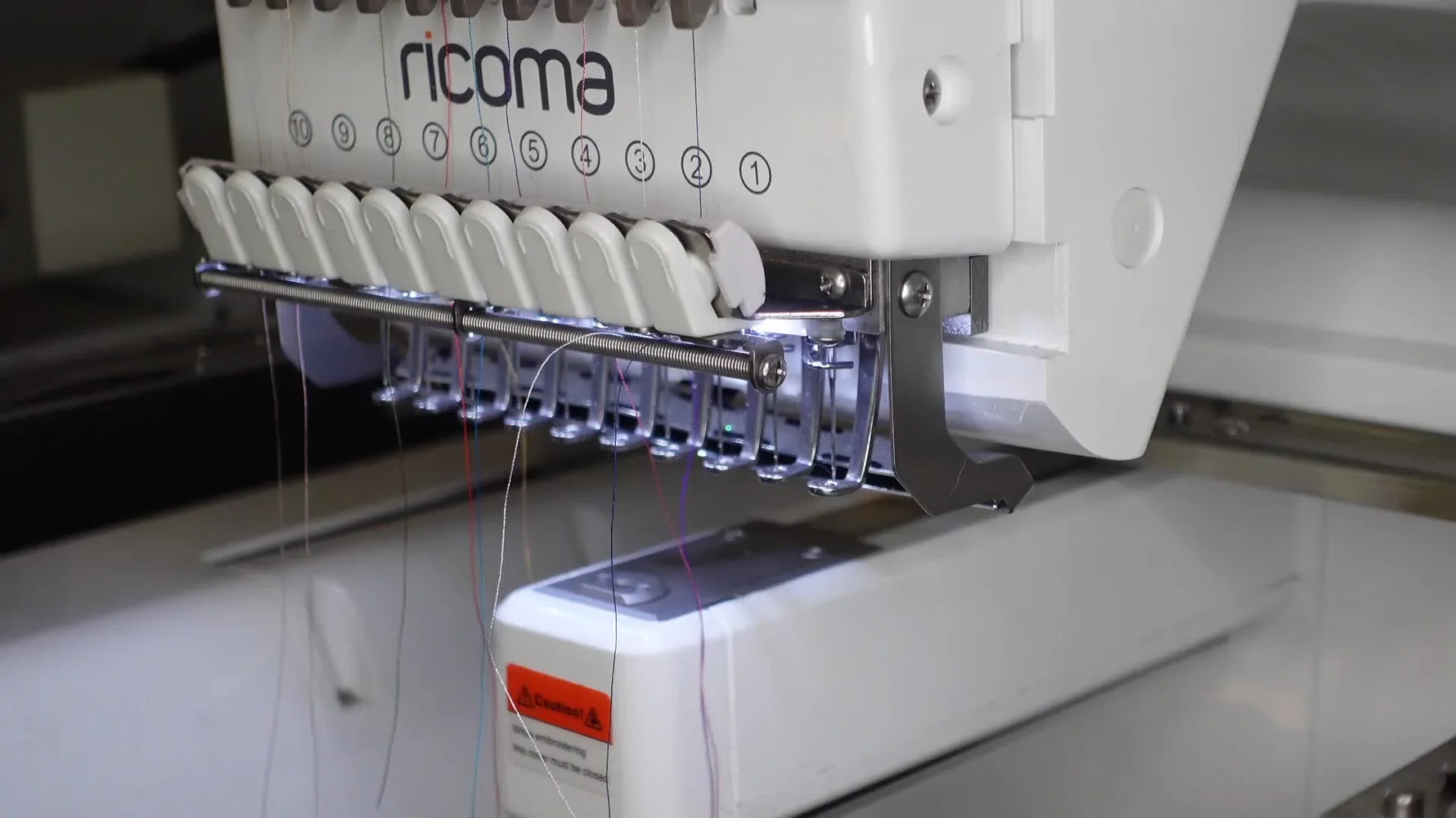 Ricoma EM-1010 embroidery machine head with needles and threads