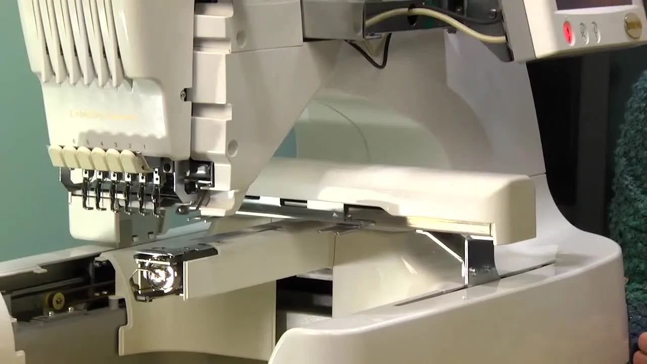 Close-up of the Baby Lock 6-needle embroidery machine arm and needle area, setting the stage for a safe firmware update routine.