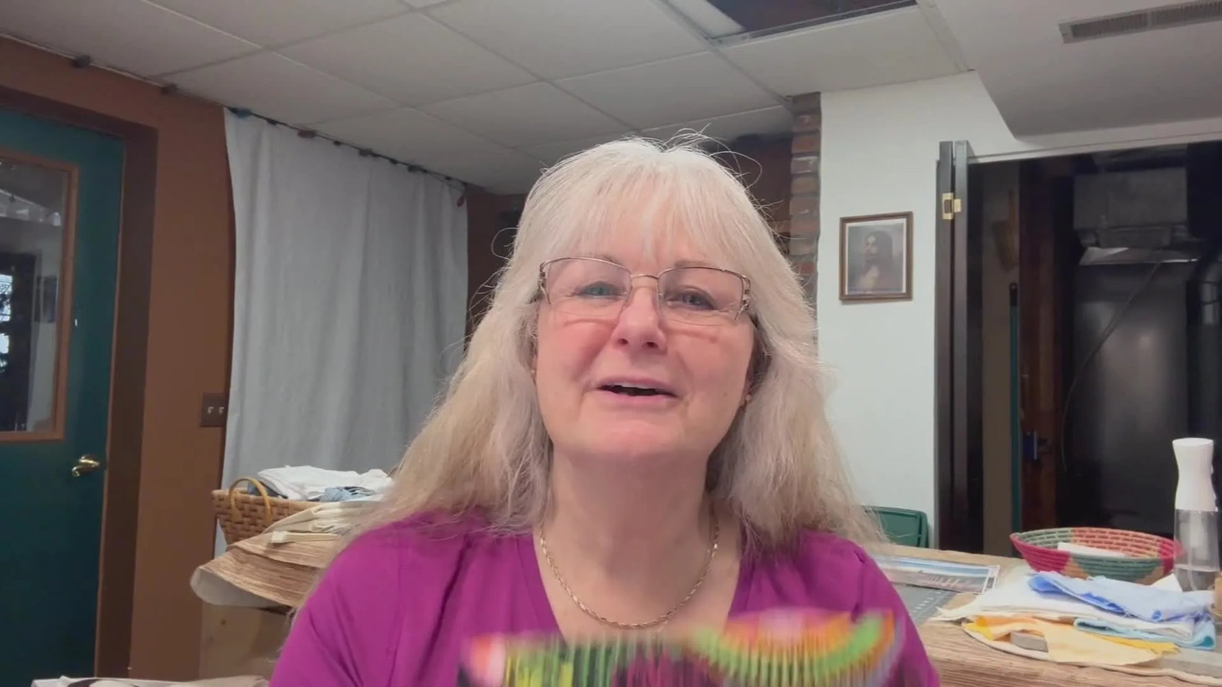 A close-up of the finished Flower Power wallet held up to the camera, showing the final embroidery and overall shape.