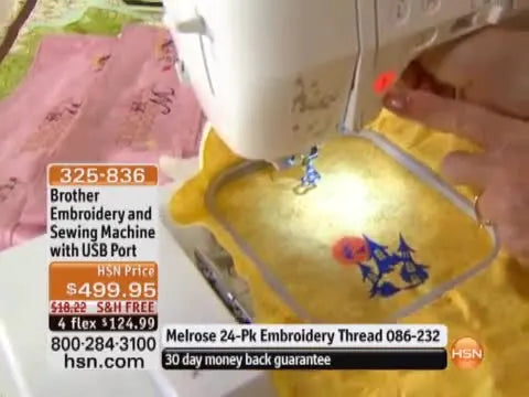 A close-up of the illuminated green Start/Stop button being pressed as the Brother embroidery machine begins stitching.