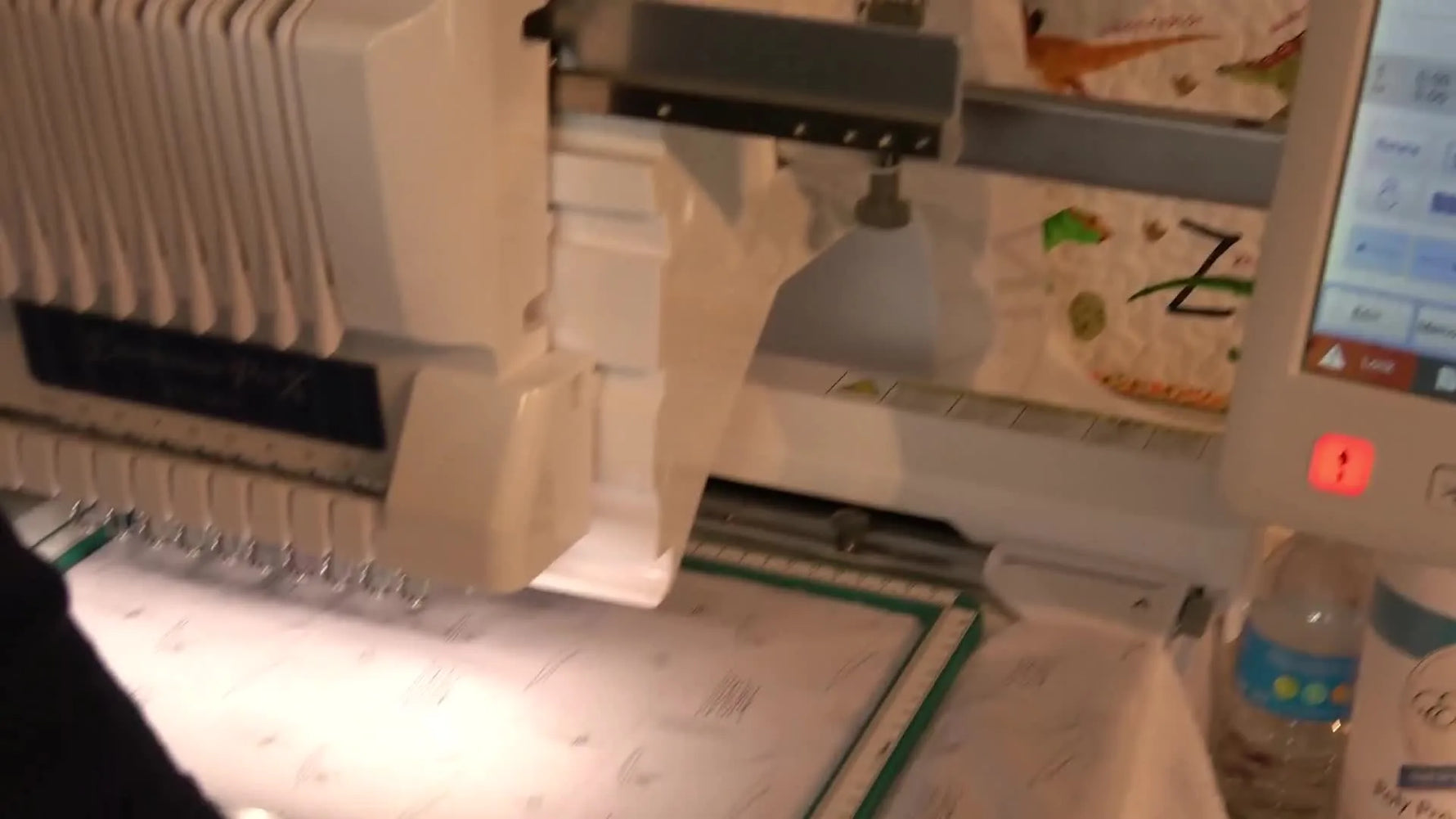 A Brother 10-needle machine traces the design area on a magnetic hoop to confirm placement before stitching a batch of cornerstones.