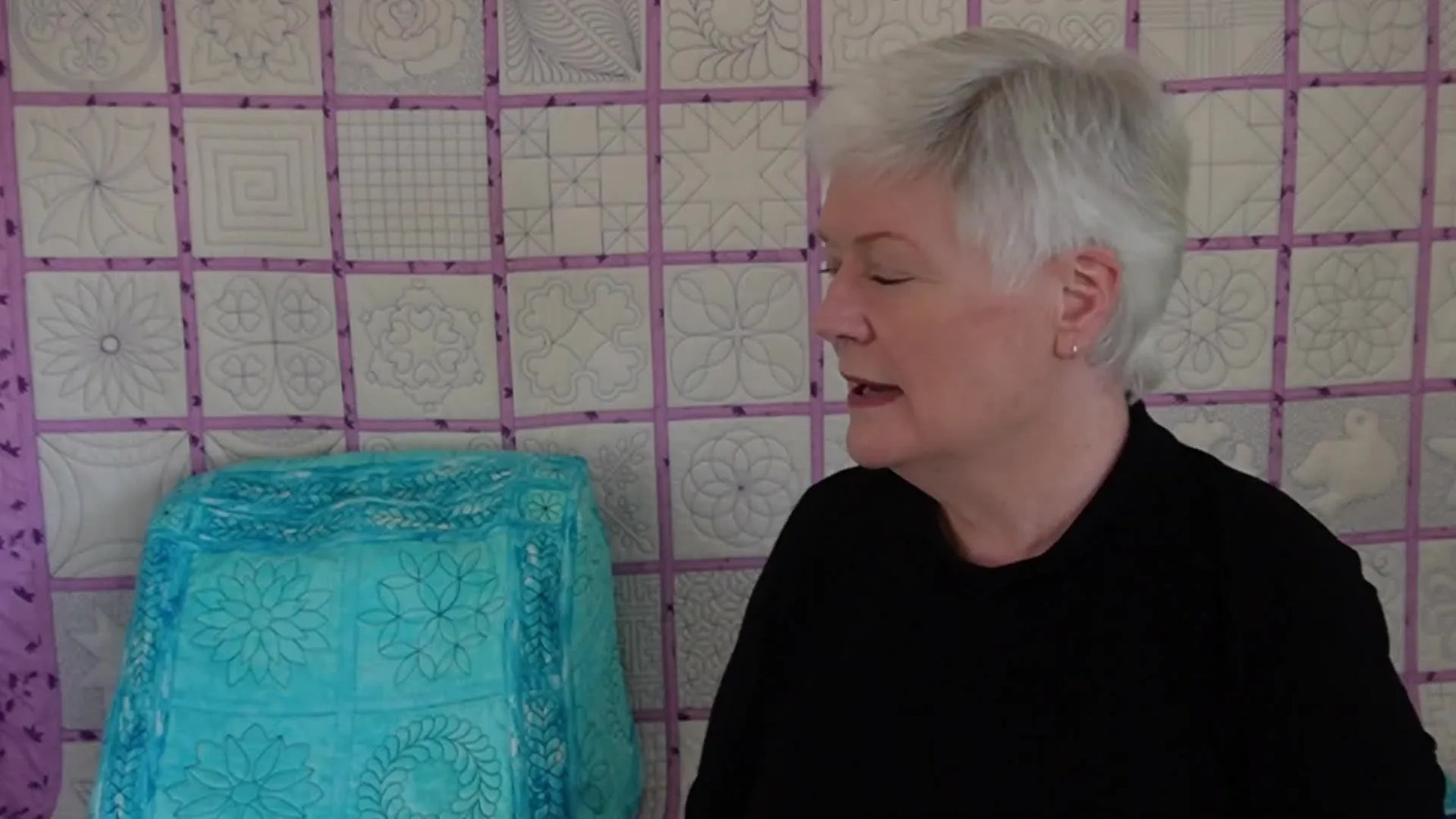 A finished teal quilted cover sits neatly over the Janome 2000D Air Threader, showing the final look you’re planning toward.