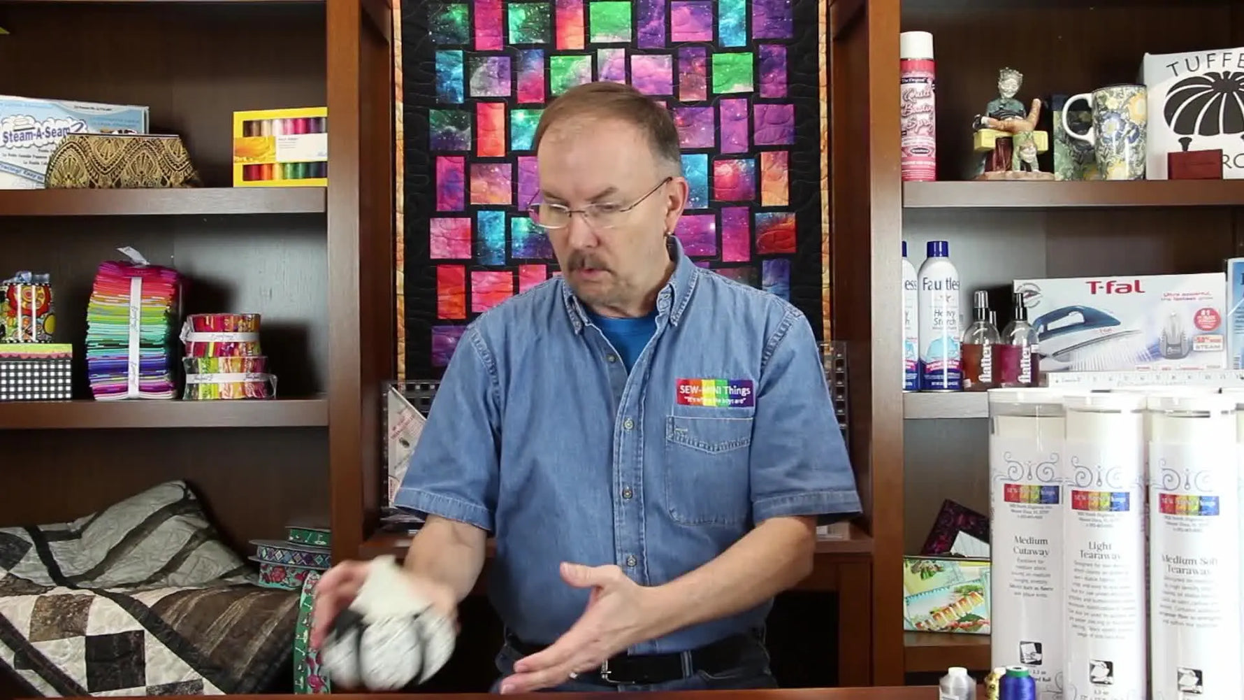 A close-up of a finished 3D embroidered pumpkin ornament being held up to show what an embroidery machine can produce.