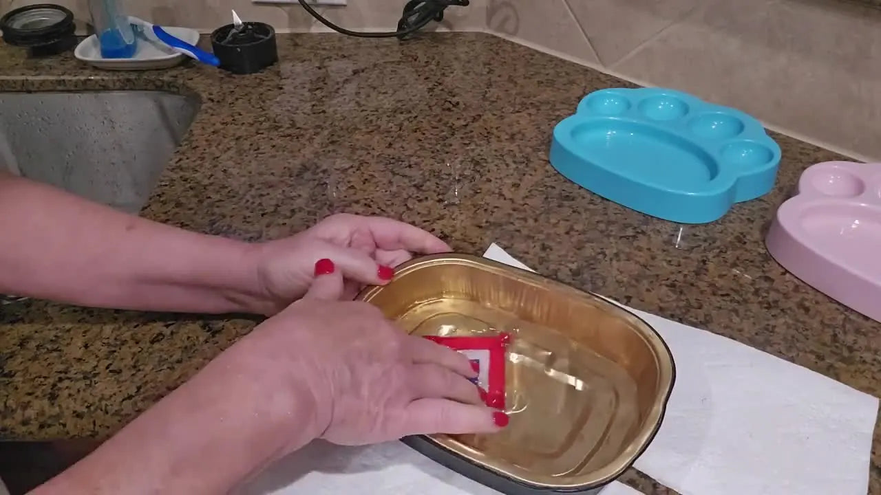 A close-up shows the freestanding lace tag being dipped into hot water as the water-soluble stabilizer vanishes.