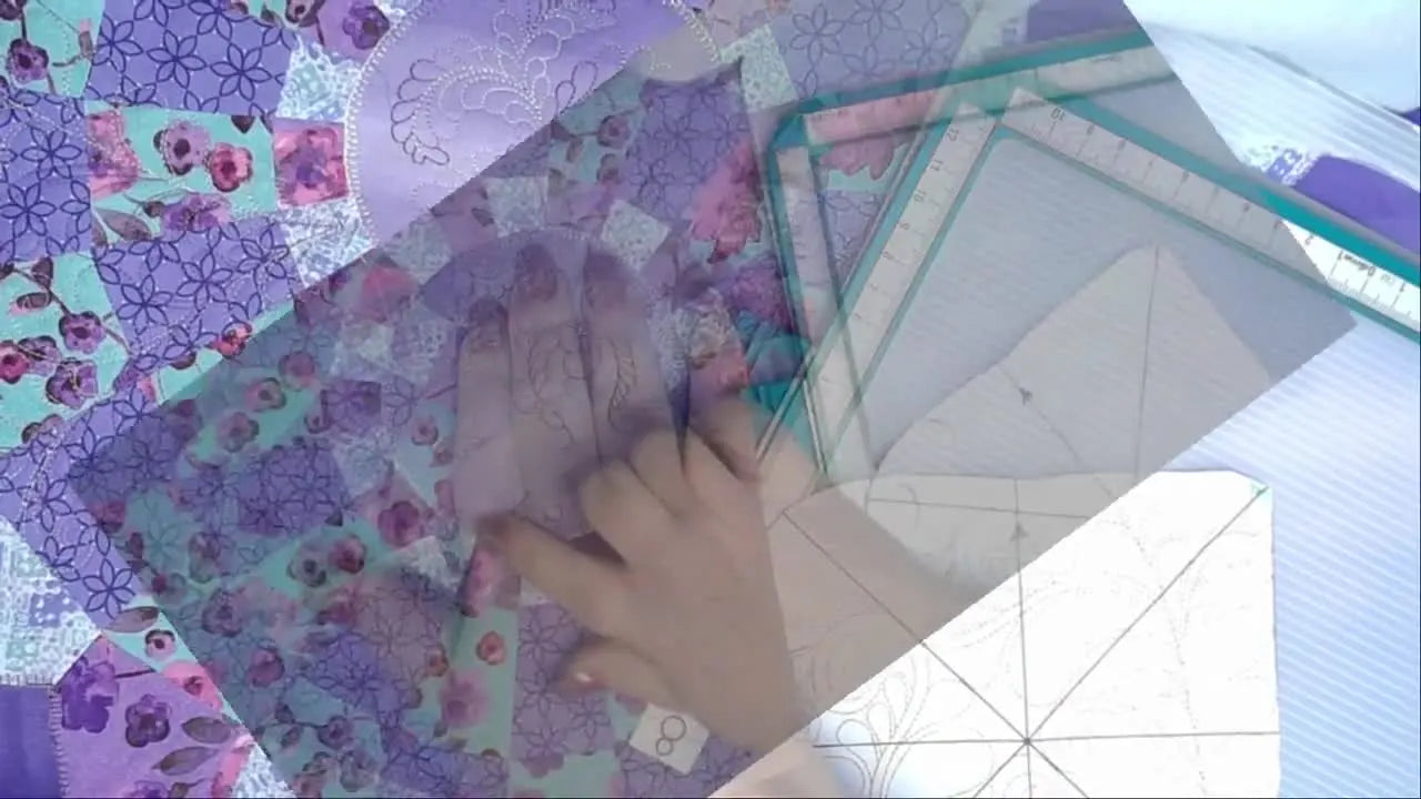 A close-up of a finished quilt block stitched with feather-style quilting in variegated thread on purple patchwork fabric.