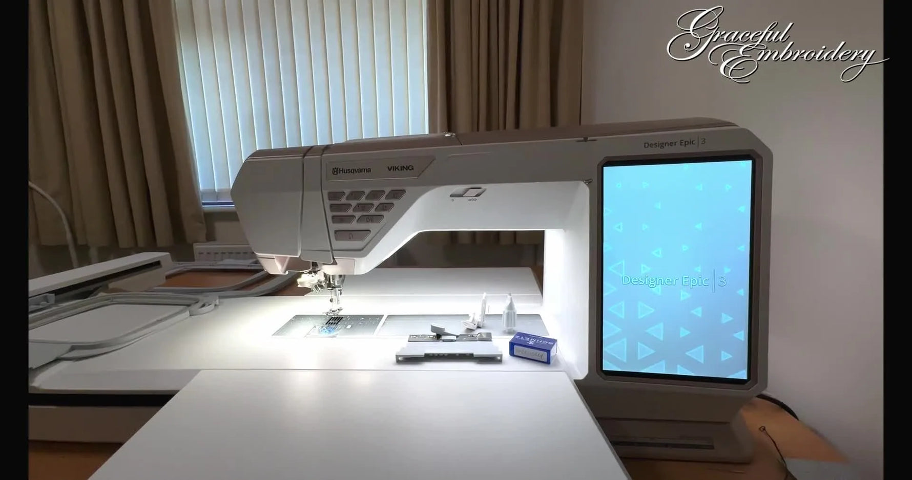 A wide view of the Husqvarna Viking Designer Epic 3 with its large touch screen lit up, ready for embroidery setup.